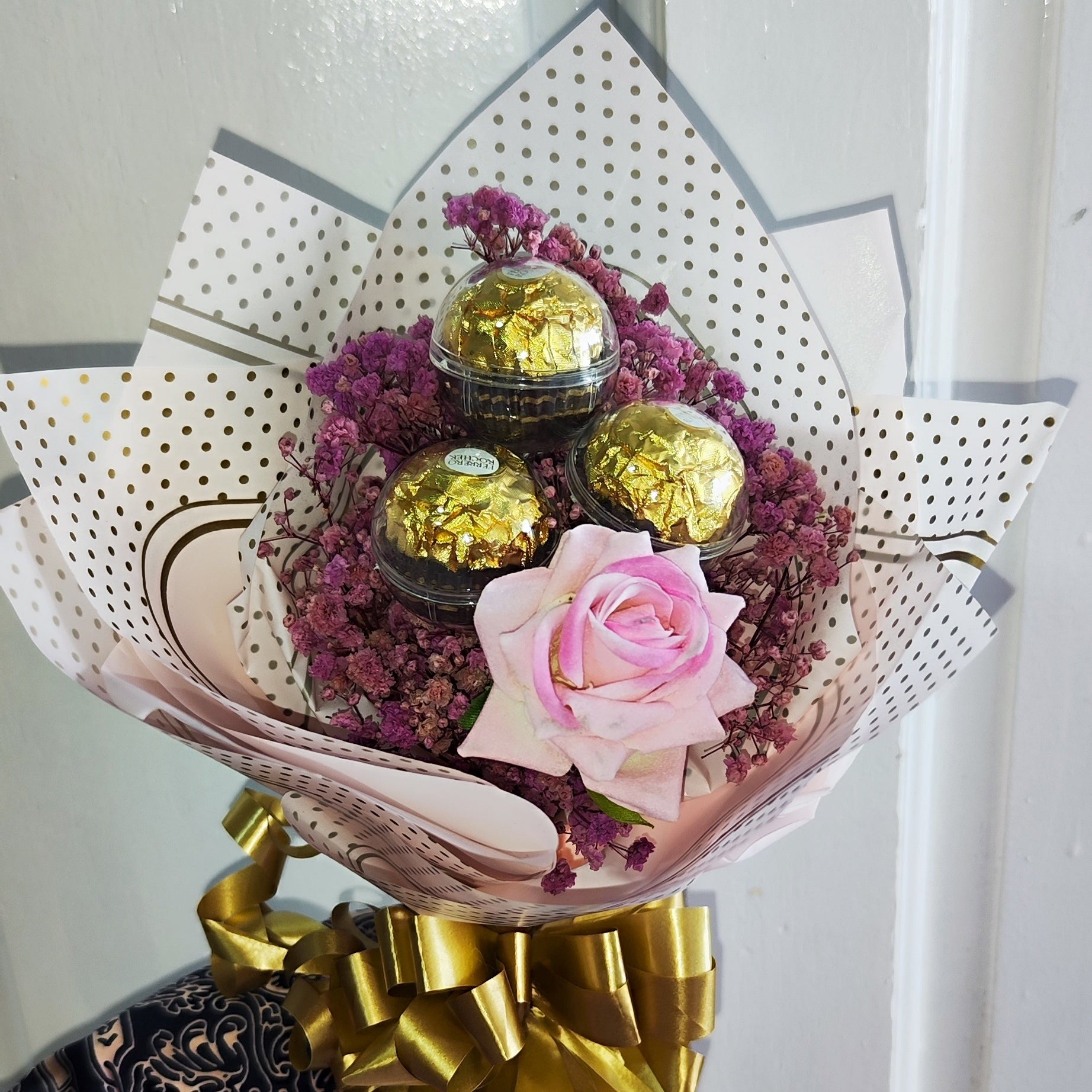 Blushing Bloom 1 consists of preserved baby's breath flowers and 1 artificial rose and paired with 3 Ferrero Rocher chocolates