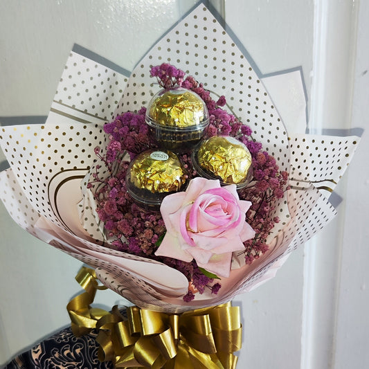 Blushing Bloom 1 consists of preserved baby's breath flowers and 1 artificial rose and paired with 3 Ferrero Rocher chocolates